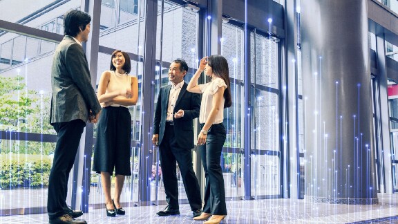 A group of colleagues chatting in an office