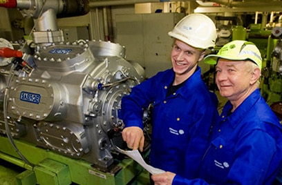 Two engineers working with an equipment
