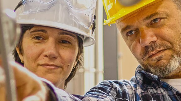 Worker pointing at tool