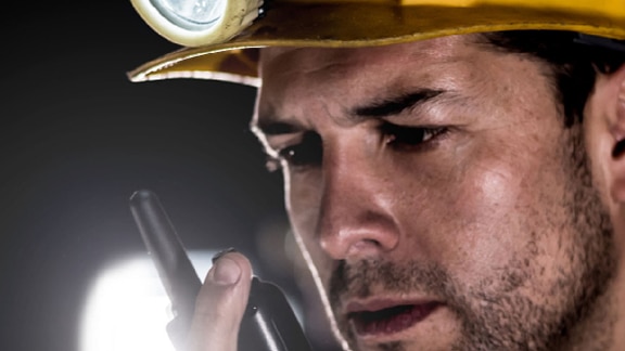 Worker speaking with communication device