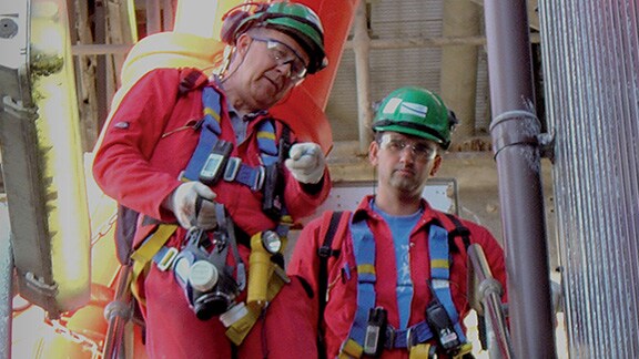 Rescue team in safety gear discussing and working