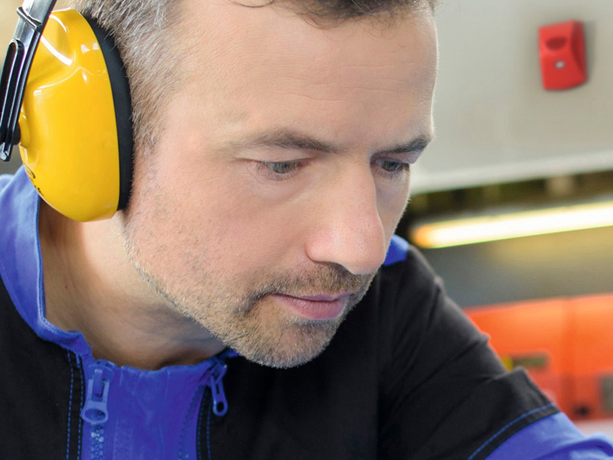 Close up of a man wearing yellow headphones