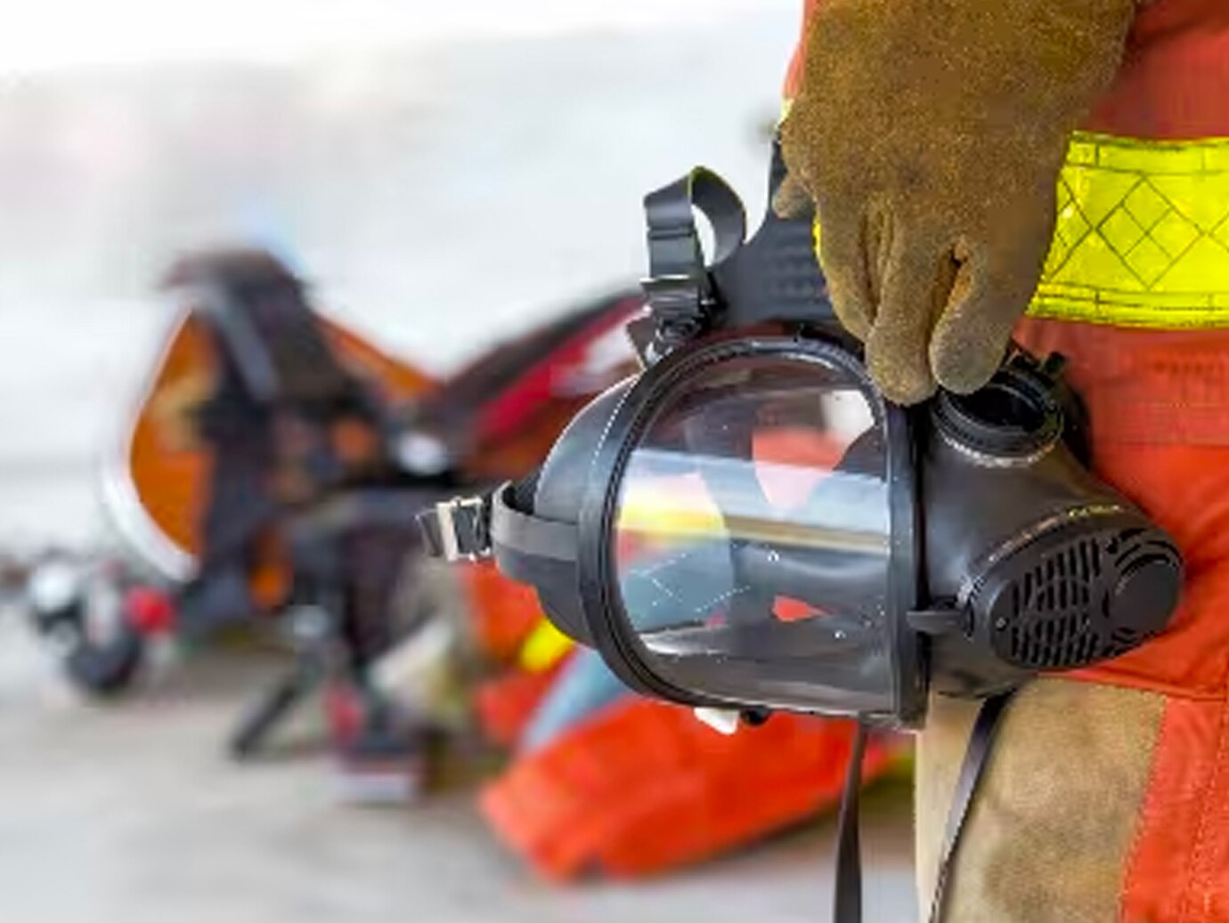 Close-up of a firefighter holding a gas mask