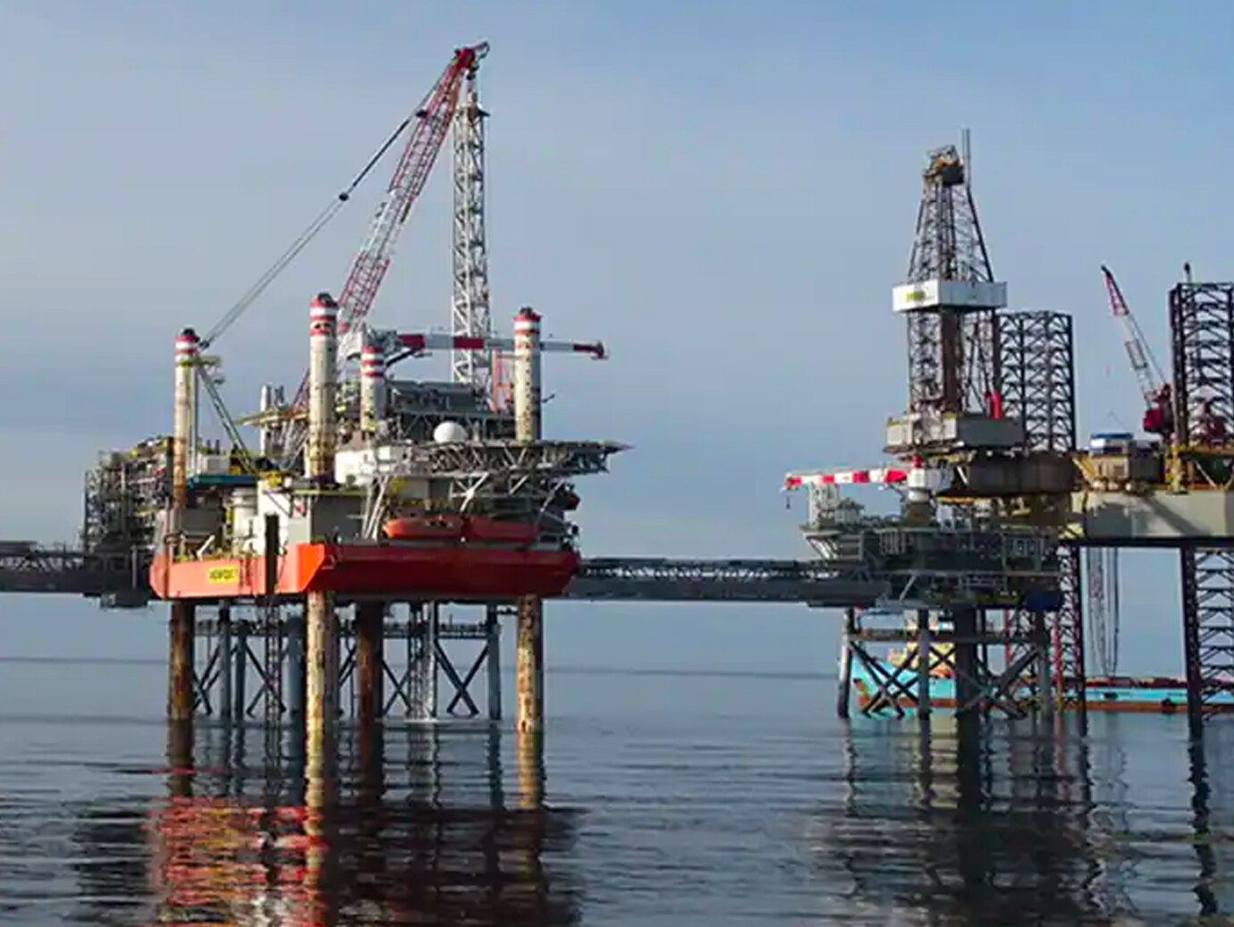 Two offshore oil rigs in operation at sea