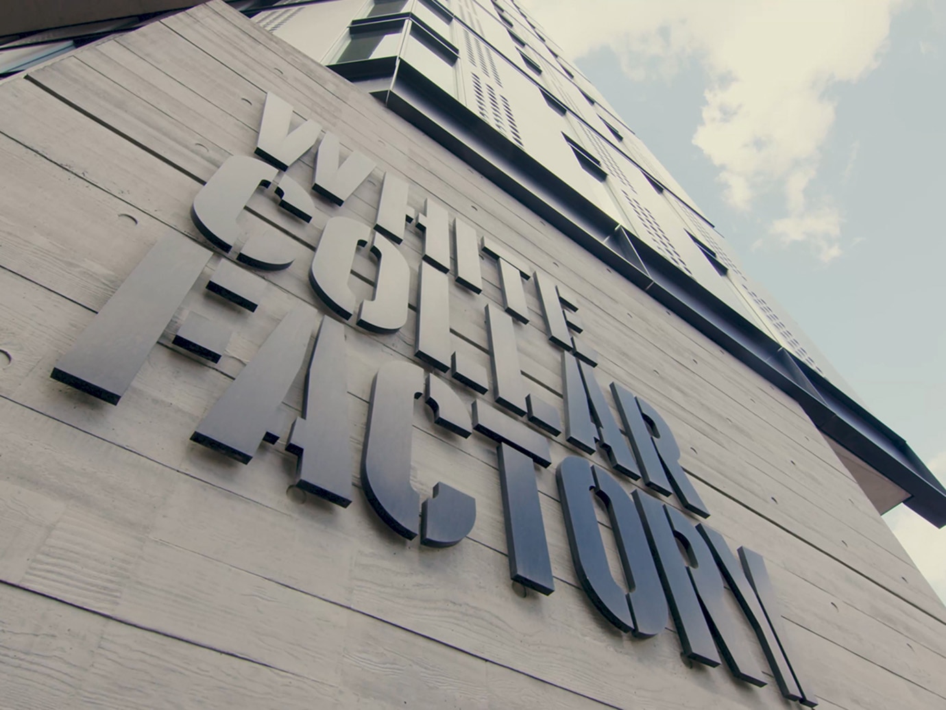 Close-up of a building with "White Collar Factory" written on it