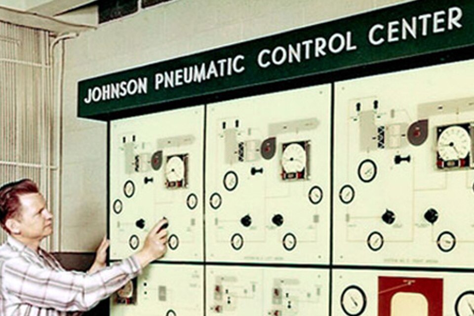 A man setting up a presentation for the Johnson Service Company's pneumatic control centers