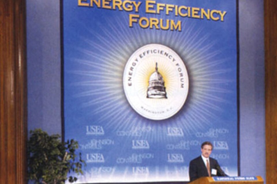A man at a podium, speaking at the Energy Efficiency Forum