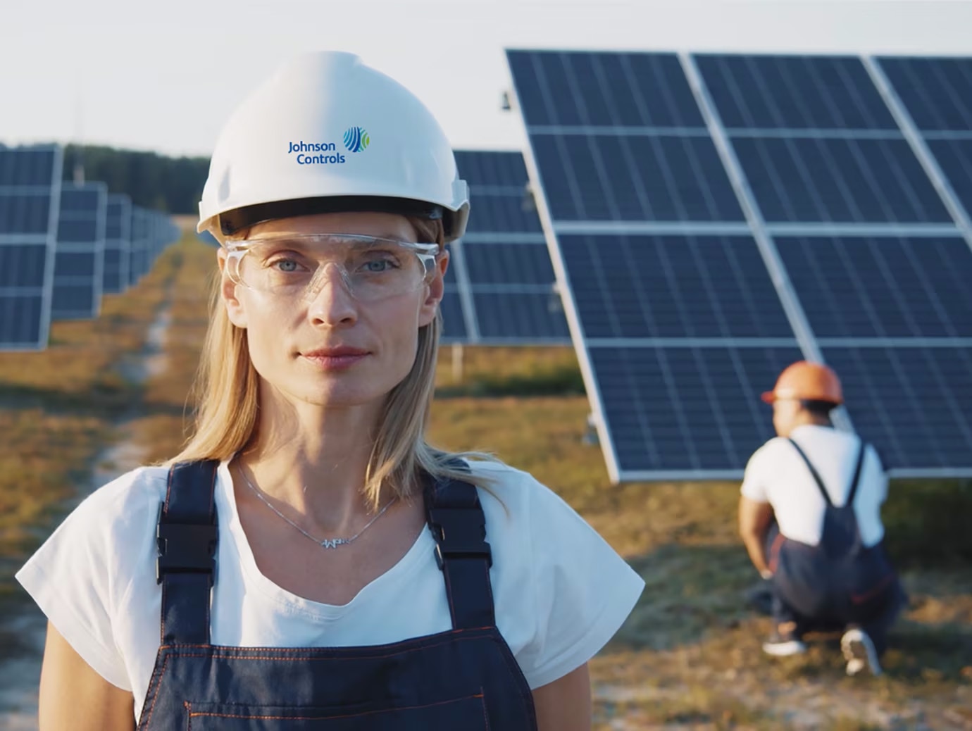Female Johnson Controls employee in a safety helmet at a solar power plant