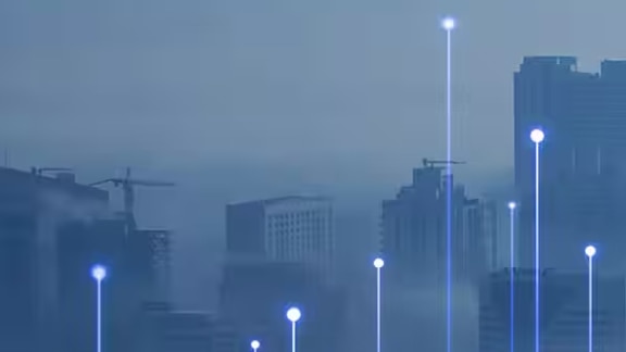 Foggy cityscape overlaid with a graphic of transmission nodes