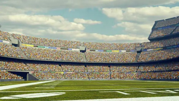 Football stadium full of spectators under blue sky