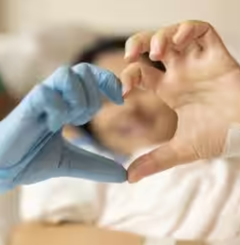 A doctor and a patient joining hands to form a heart