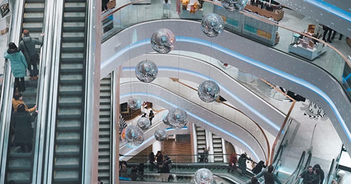 Low angle shot of inside a shopping mall with escalators