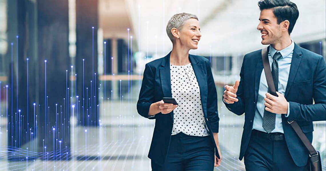 employees-chatting-while-walking-in-office