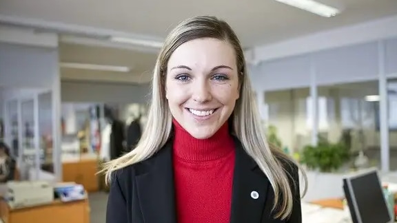 A female employee smiling at the camera in office