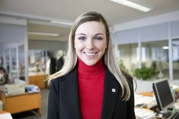 A female employee smiling in an office