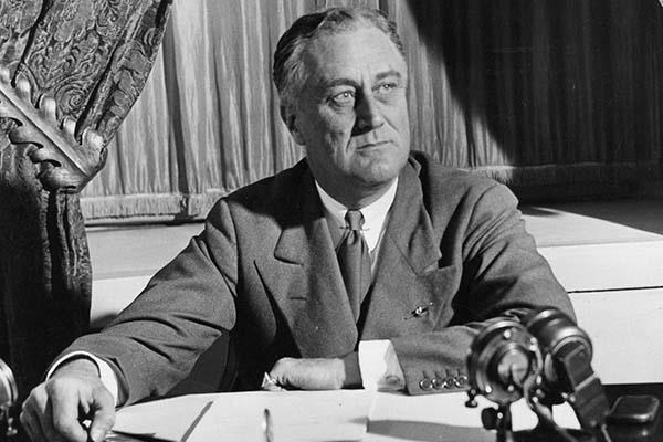 American President Franklin Roosevelt seated at a desk