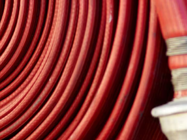 Coiled red hose reel