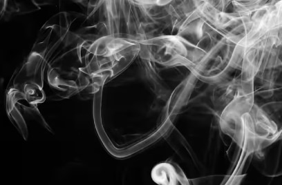 wisps of smoke against a black background