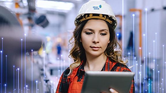 A female Johnson Controls technician using a tablet, overlaid with a graphic of transmission nodes in the backgroound