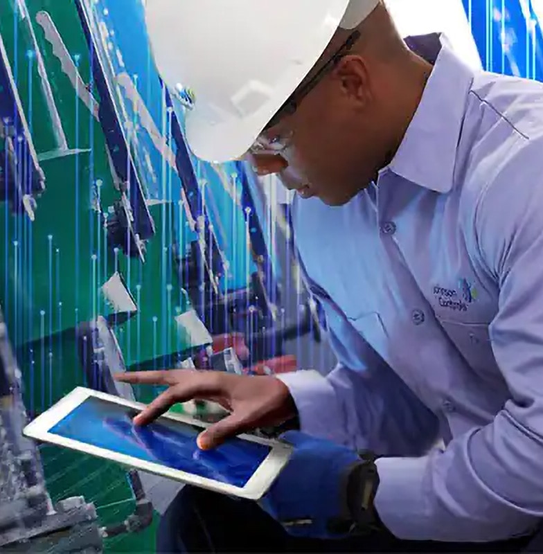 Johnson Controls technician using a tablet and inspecting HVAC equipment