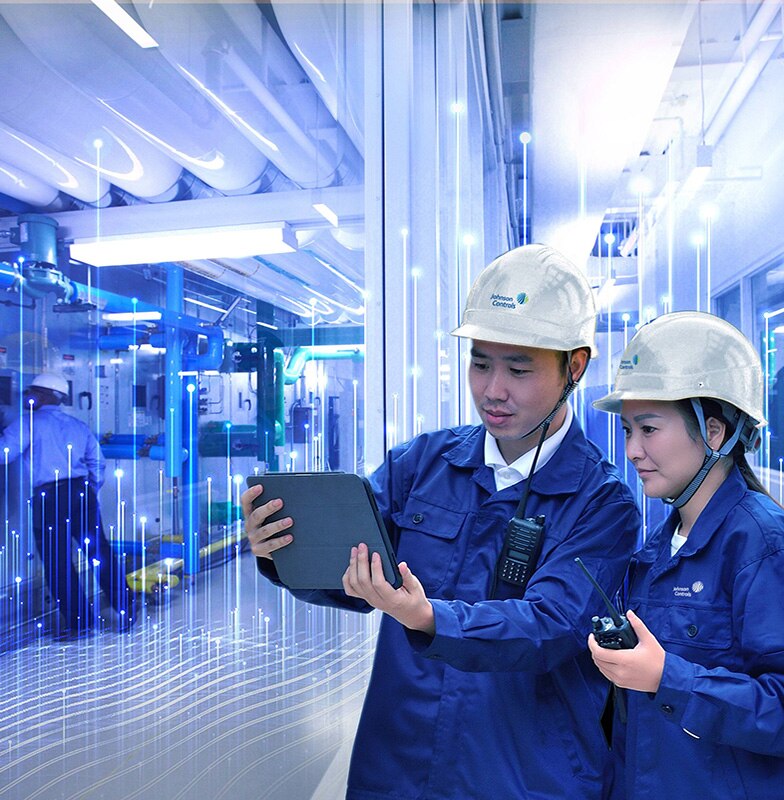 Two Johnson Controls technicians using a tablet, overlaid with a graphic of transmission nodes