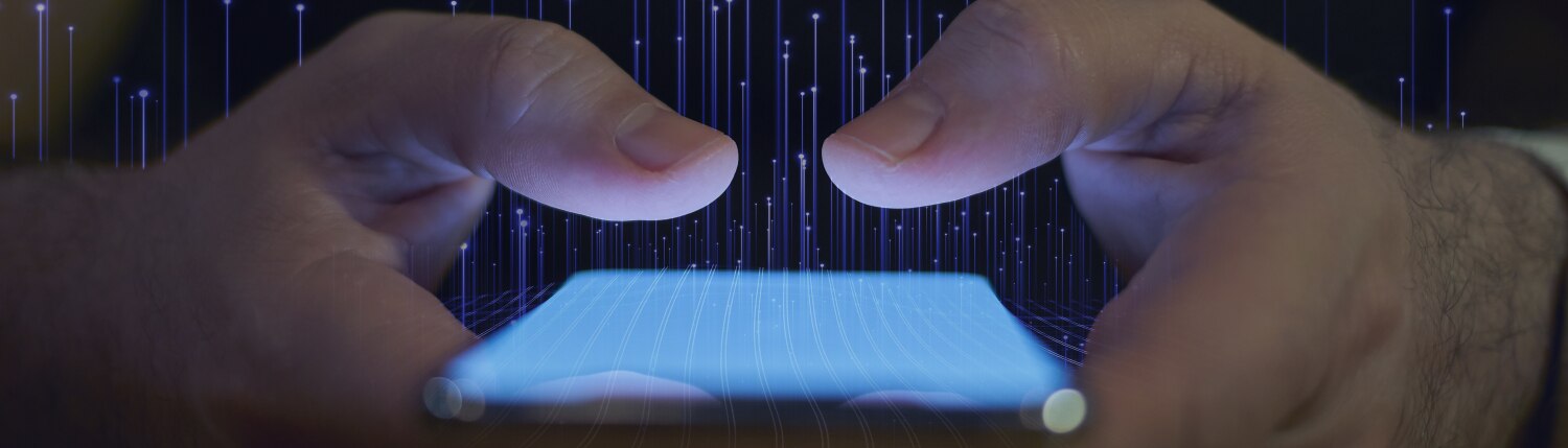Close-up of hands holding a smartphone with graphic of transmission nodes overlaid in the background 