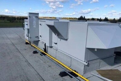 A light gray rooftop unit installed on a roof