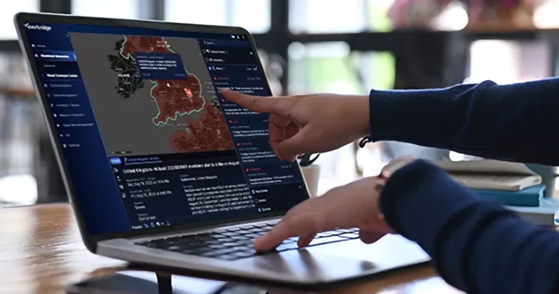 Finger pointing at a map open on a laptop screen