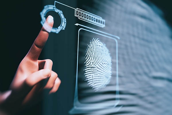 A person giving their fingerprint impression for access