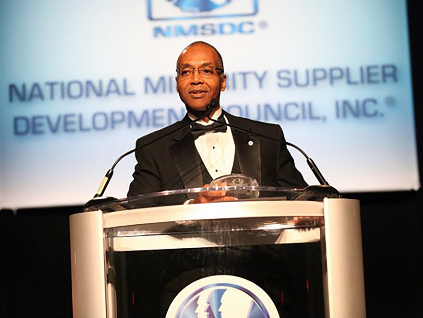 Reginald Layton, executive director of supplier diversity & business development receiving an award