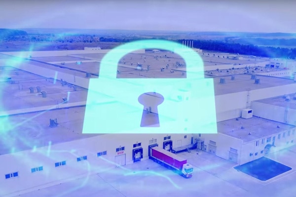A parking lot for trucks in a factory, with a graphic of a padlock overlaid on it