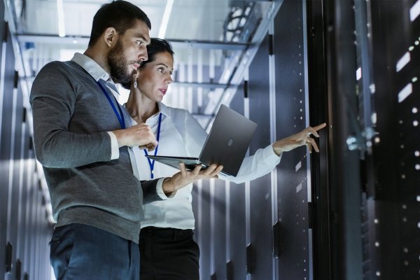 Two people in a data centre working on a laptop small image