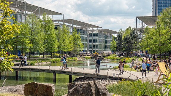 People walking along a bridge in a business park